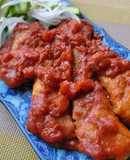Cheese and pork stewed in⁢ tomato sauce